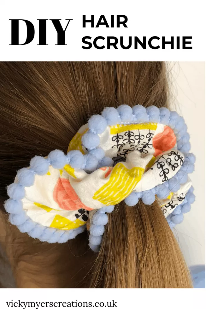 Learn how quick and easy it is to sew up a scrunchie with pompom trim. DIY scrunchies are perfect for sewing up scraps of fabric.